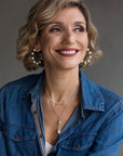 Woman wearing a blue denim shirt with a neutral background